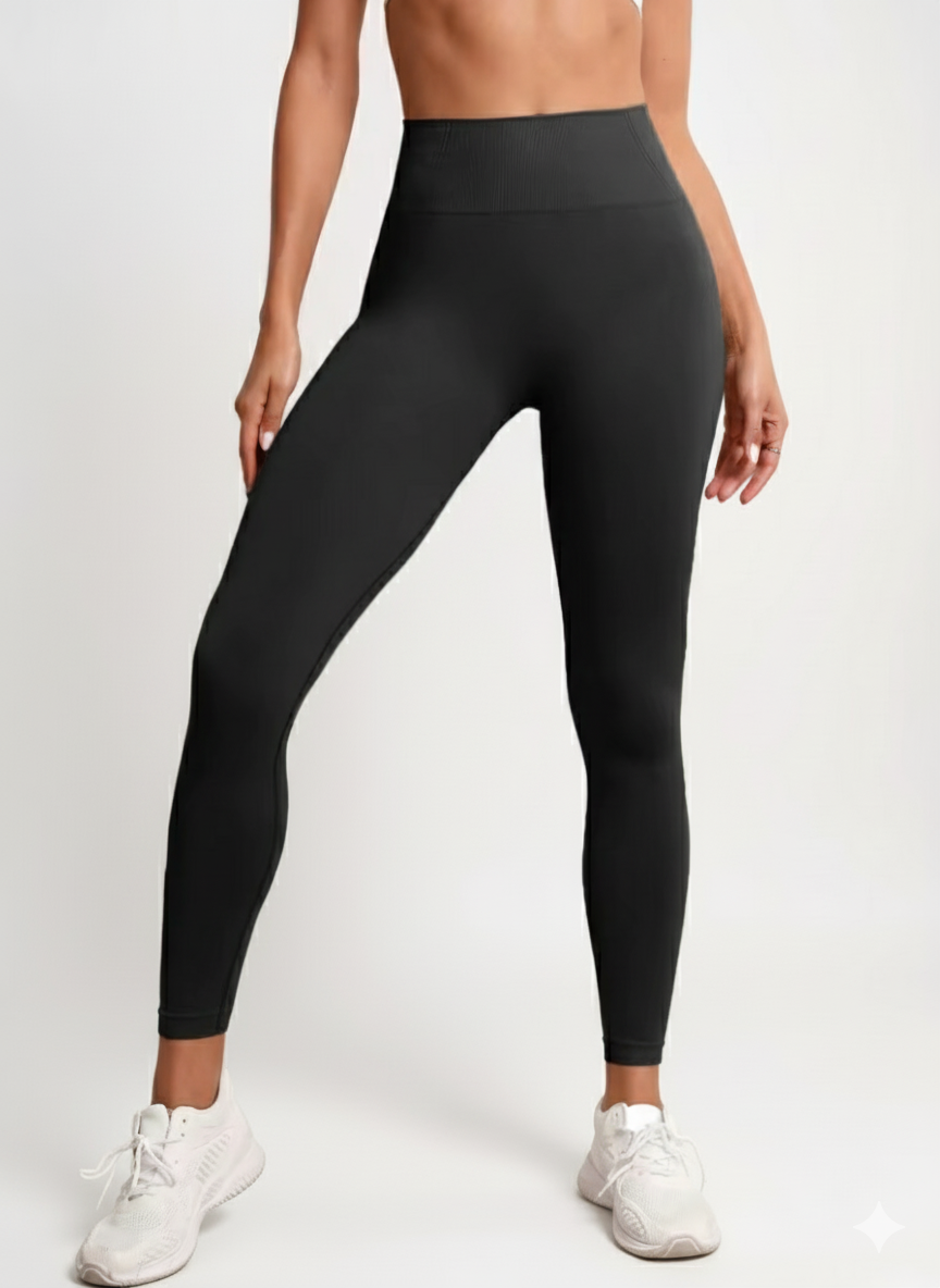 Person wearing black leggings on a white background